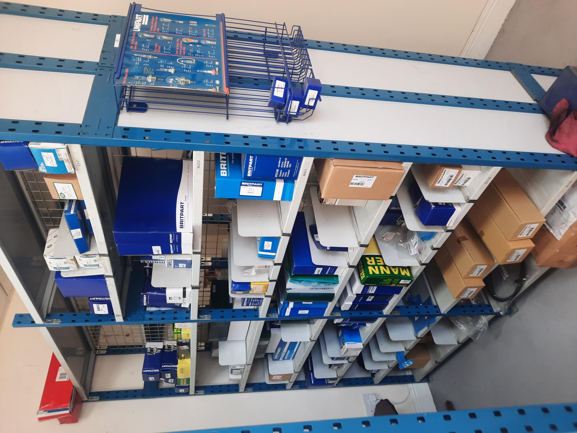 Aisle of shelving stacked with boxed vehicle parts
